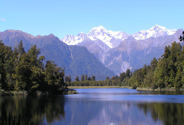 Take a short walk to Lake Matheson located in West Coast and capture the perfect photograph of snow-capped Mount Cook reflected in the dark waters.