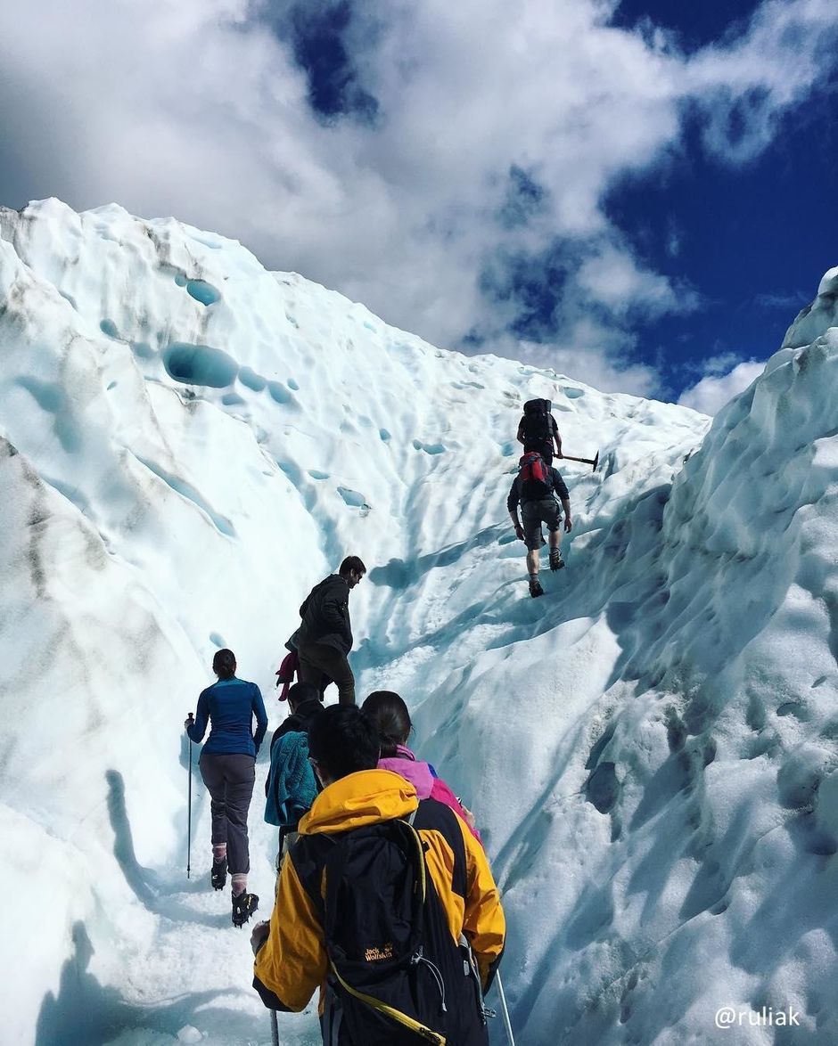 Hiking the stunning blue ice on Fox Glacier on the West Coast of New Zealand.