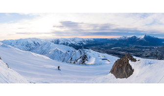 First tracks at Coronet Peak as the sun rises over Queenstown.