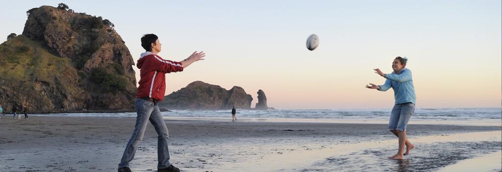 A wild New Zealand beach is a great place to toss a rugby ball around.