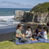 Enjoy a picnic on Muriwai Beach.