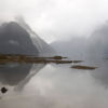 The tranquil beauty of Milford Sound shrouded in mist.