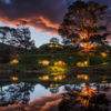 The Hobbiton™ Movie Set in the lush countryside setting of Matamata is a spectcular sight at sunrise or sunset.