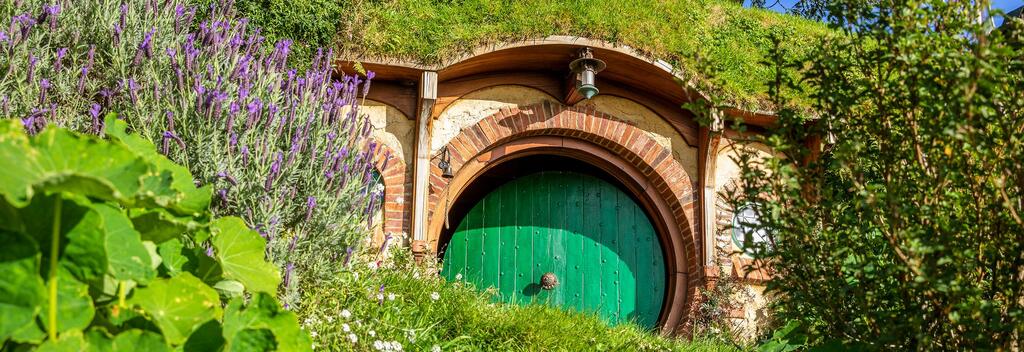 Sheltered by tall trees, the hobbit holes at Hobbiton Movie Set are beautifully detailed.