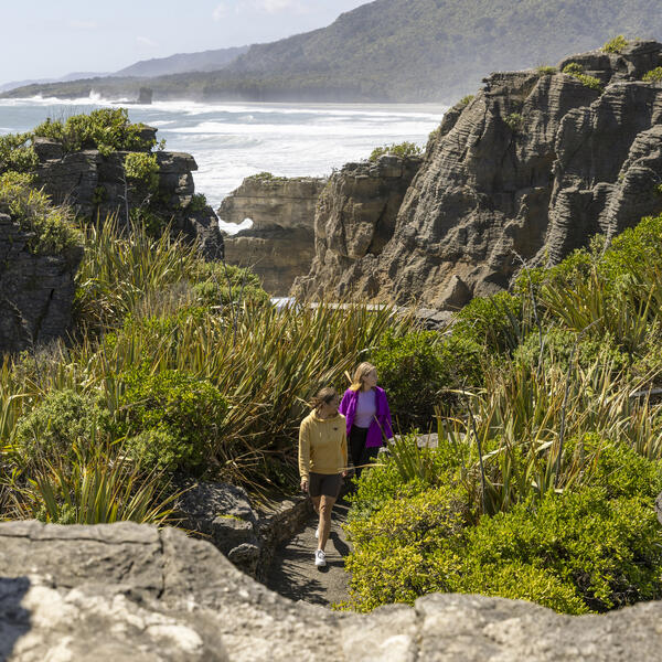 Ppeople walking at Punakaiki Pancake Rocks and Blowholes Walk, Paparoa National Park, West Coast of New Zealand