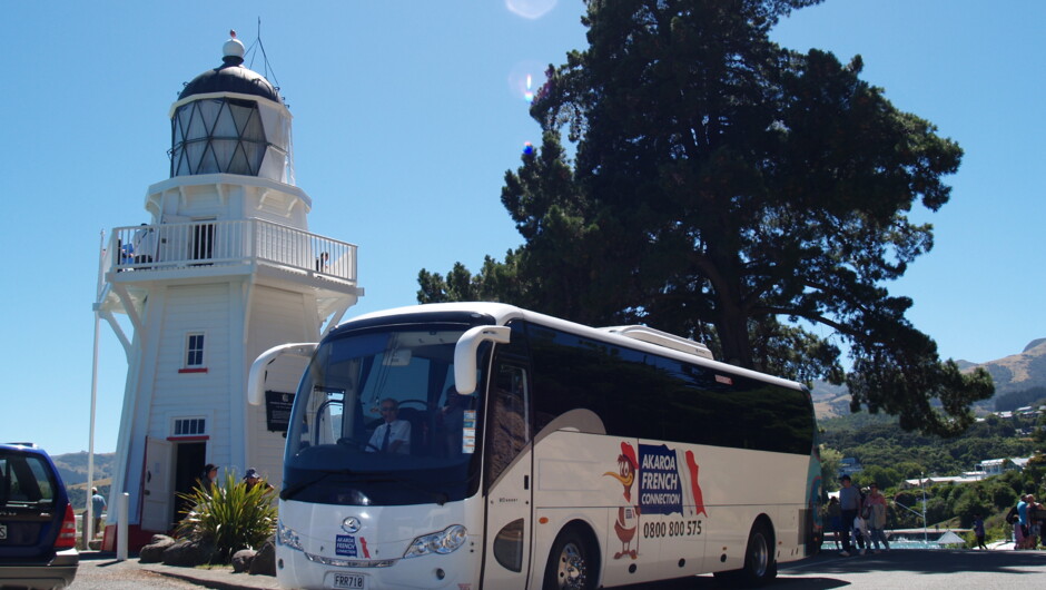 Coach parked beside the historic Akaroa lighthouse