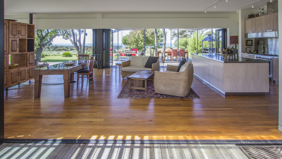 Common House - Kitchen and dining area with sliding doors onto BBQ area.