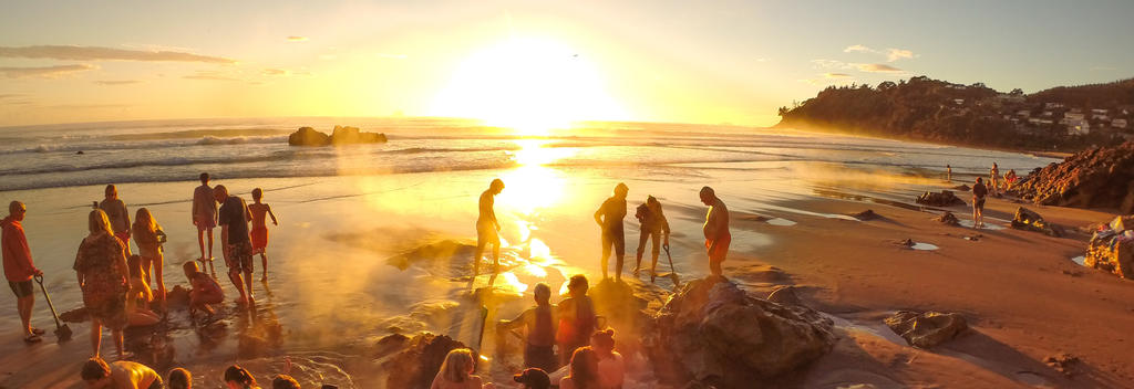 Its a community spa at sunrise on Hot Water Beach in The Coromandel.