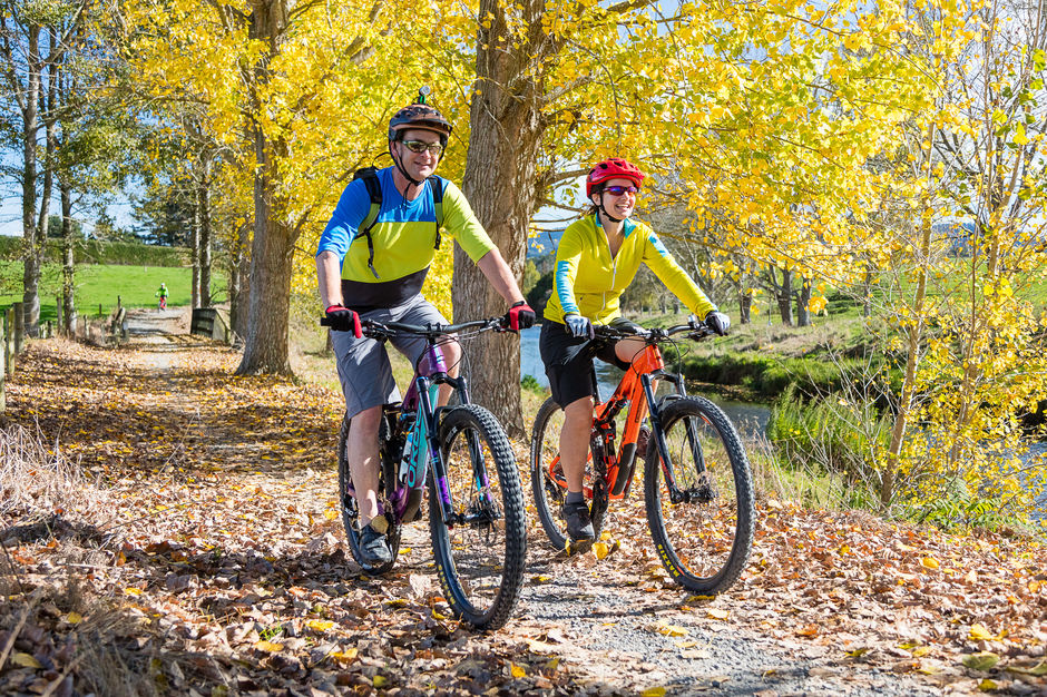 Couple cycling in Autumn, Hauraki Rail Trail,