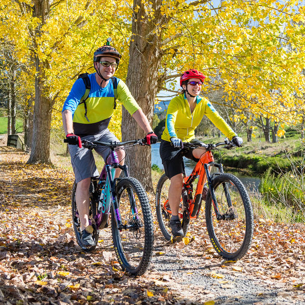 Couple cycling in Autumn, Hauraki Rail Trail,