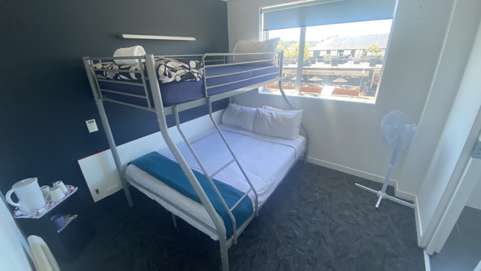 Our budget private room includes a double bed with single bunk above. It's very own private bathroom, free tea and coffee, and a heater or fan for those cool or warmer nights. Up to 3 guests can stay in this street side room.