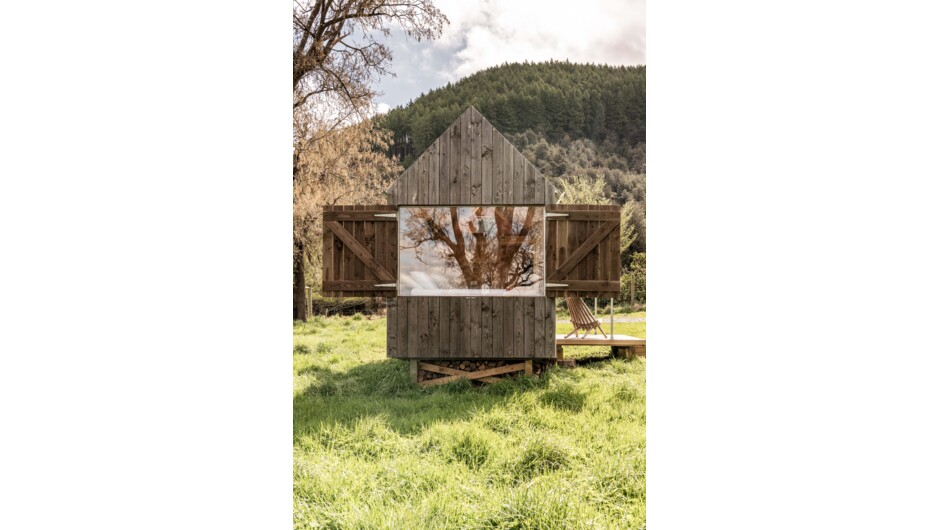 Barn style timber shutters open to reveal the built-in queen bed.