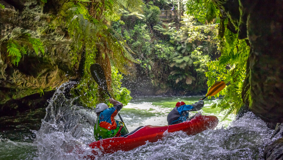 About to fly off the 7 meter high Tutea Falls in a tandem kayak.