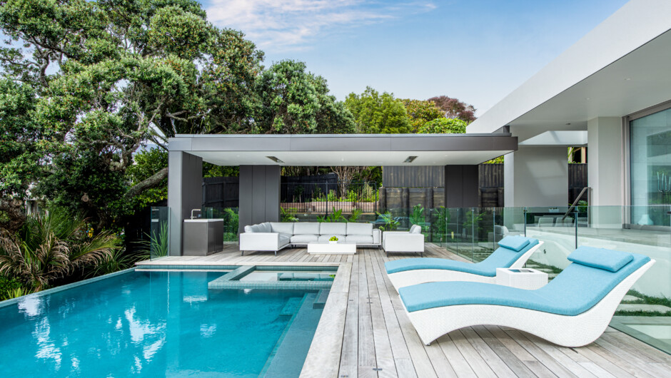 Covered pool lounge with in-ceiling speakers, over head heaters and a refreshments fridge.