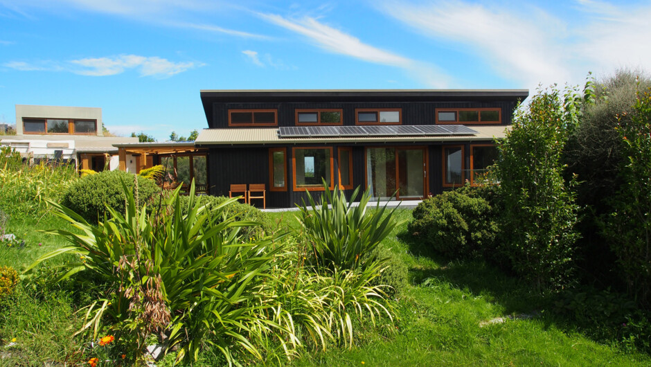 North side of Kotare accommodation, from the garden. Covered courtyard separates this from owners' Award-winning eco-friendly home (at left).