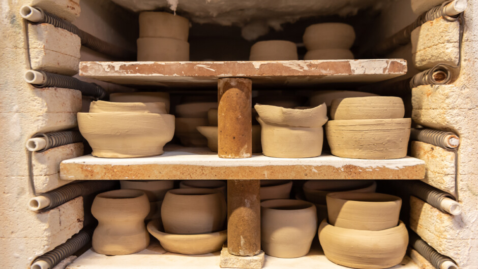 Student work stacked in kiln to be fired.