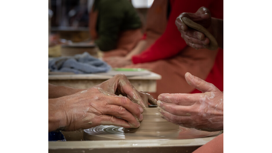 Close up of hands making a mug.