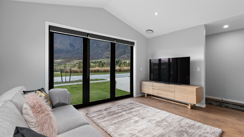 Lounge with bi-fold doors opening out to the lawn.