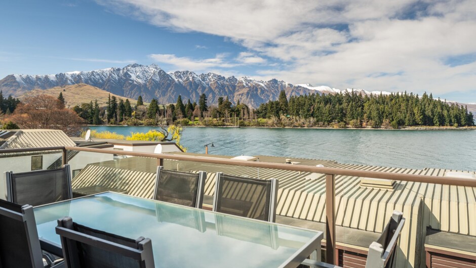 Private balcony with outdoor dining and lake views