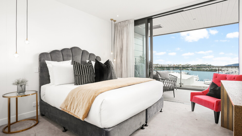 Spacious master bedroom with balcony access, a walk in wardrobe and an ensuite