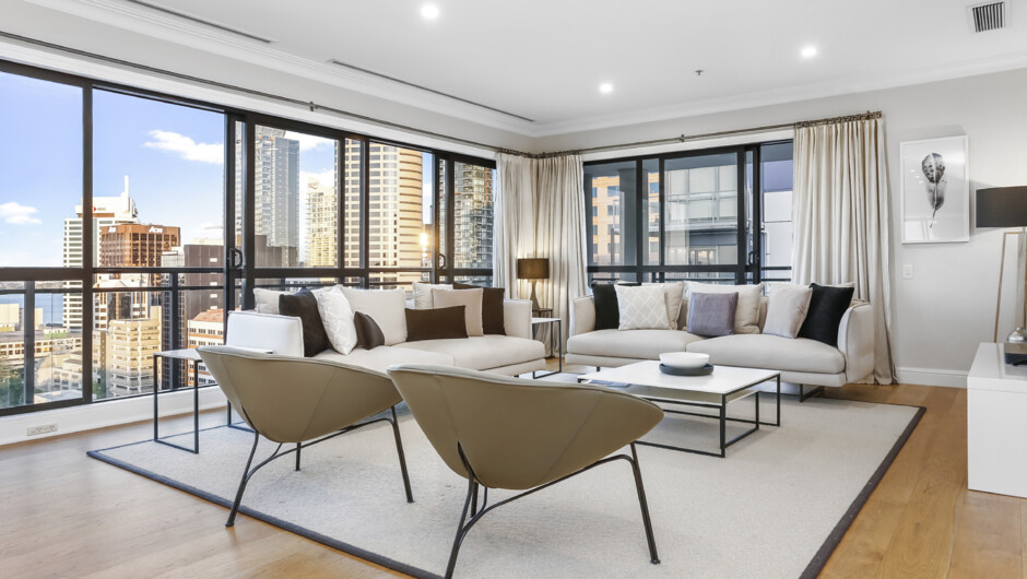 Modern styled living room flows out to the balcony with amazing views over Auckland City