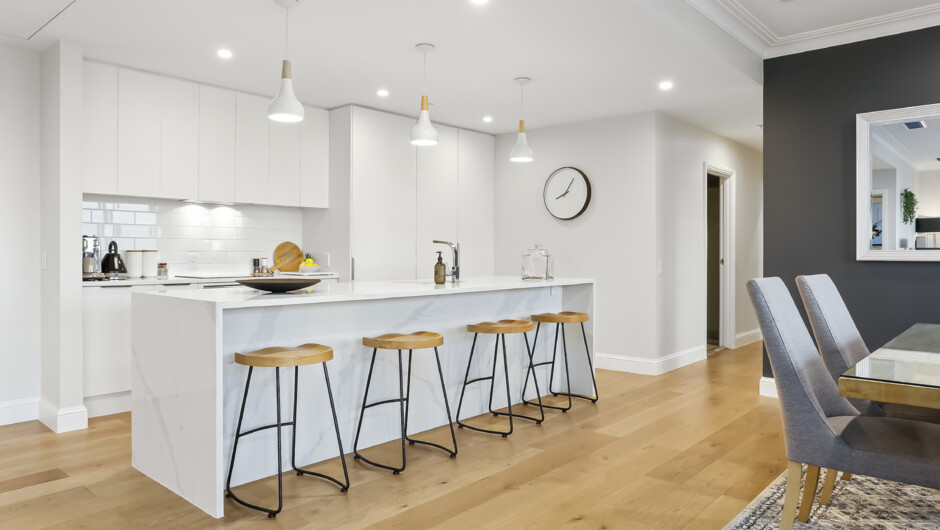 Spacious kitchen area equipped with modern appliances and cooking essentials