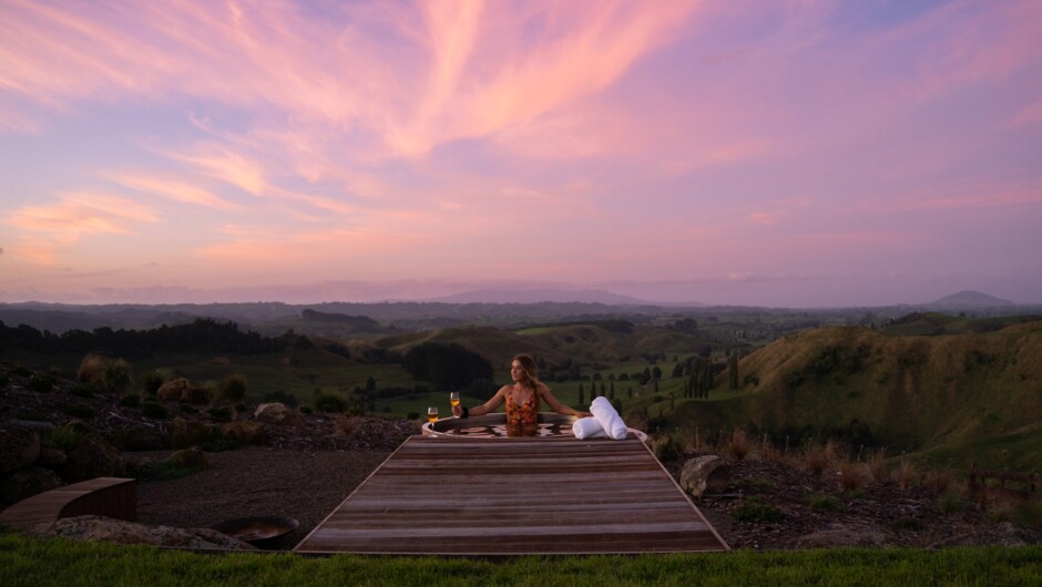 Hot tub with a view of the rolling hills of Waitomo.