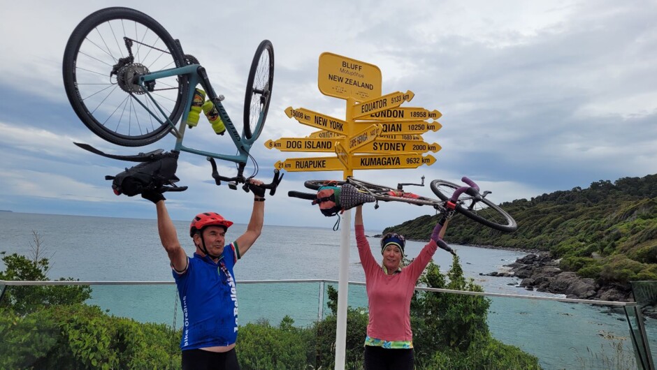 Arriving at the famous Bluff signpost marks the end of your epic adventure by bike. Time to celebrate.