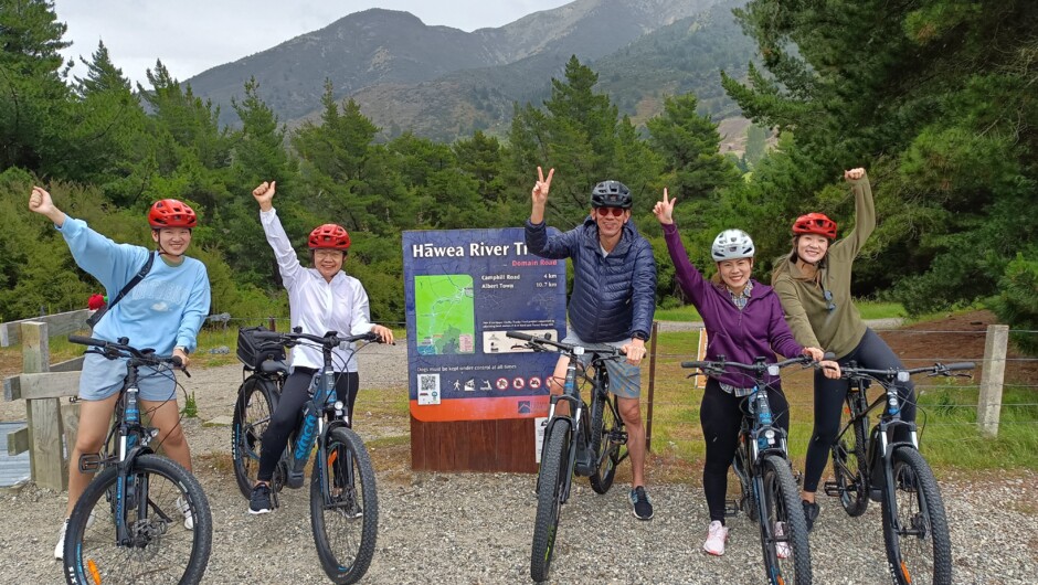 An e-bike riding family starting the Hāwea Trails. The e-bikes have 4 levels of assist and can be ridden in 'off' mode. Each bike is set up for trail riding including a day pack on the rear rack.