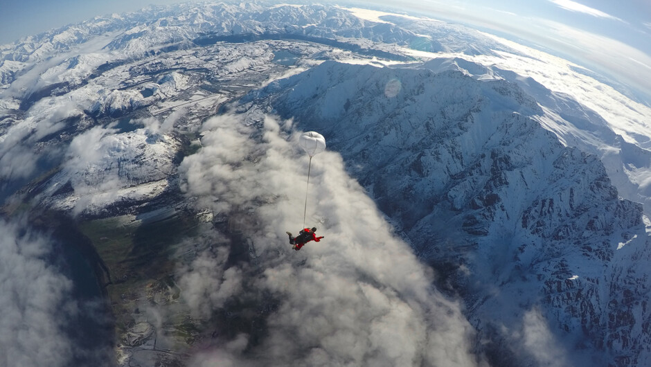 Skydive high above Queenstown alpine resort, over crystal clear lakes and snow-capped mountains.