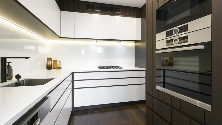 Kitchen comes equipped with modern appliances and cooking essentials