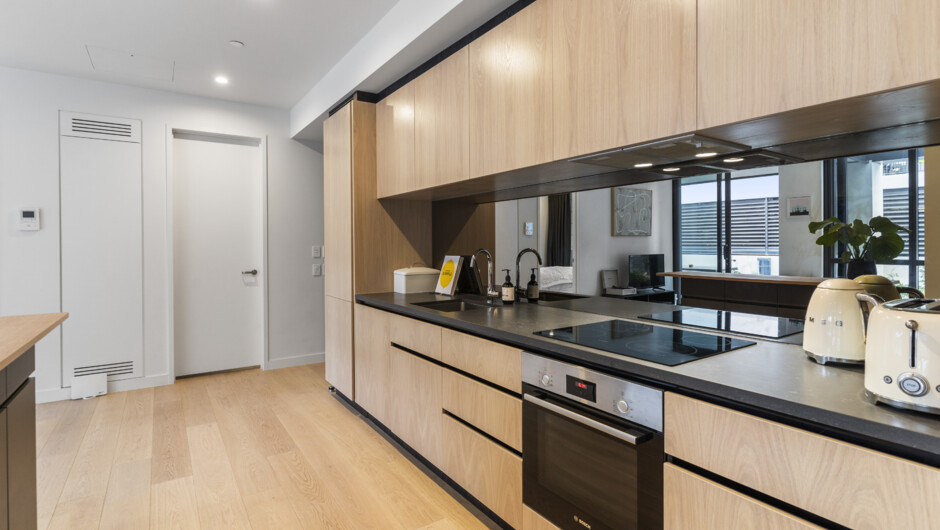 Spacious kitchen area comes equipped with modern appliances & cooking essentials