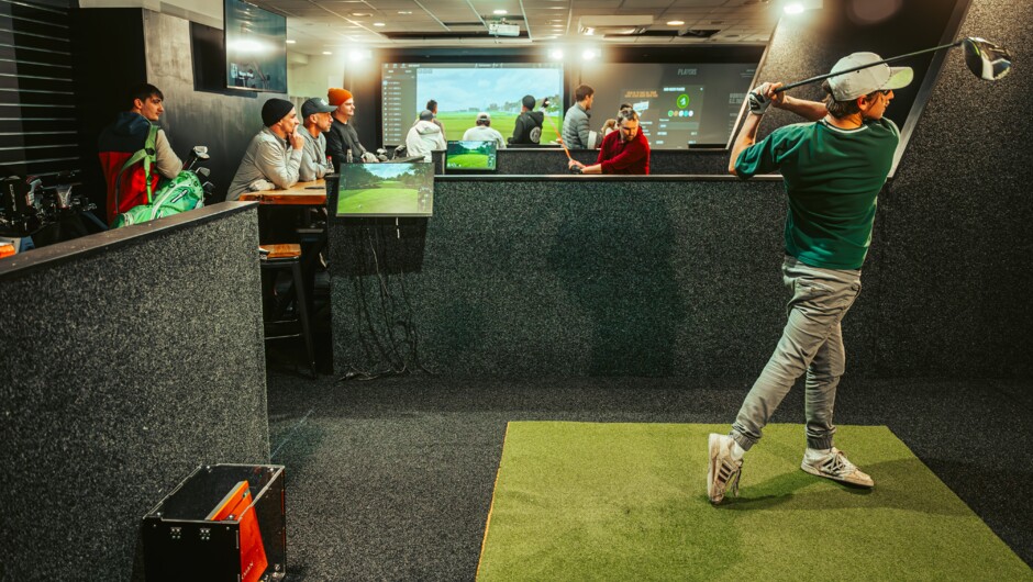 Playing indoor golf at Golf Federation.