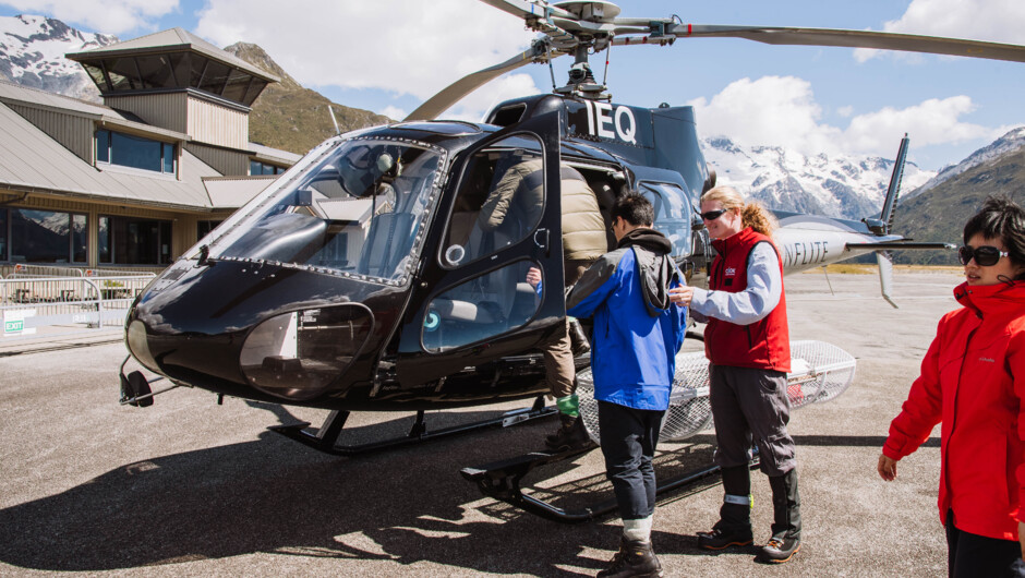 Passengers loading up into the helicopter.