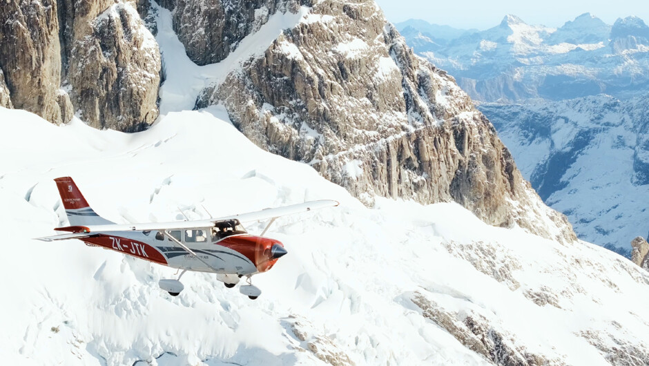 Glenorchy Air modern aircraft flying through the Southern Alps.