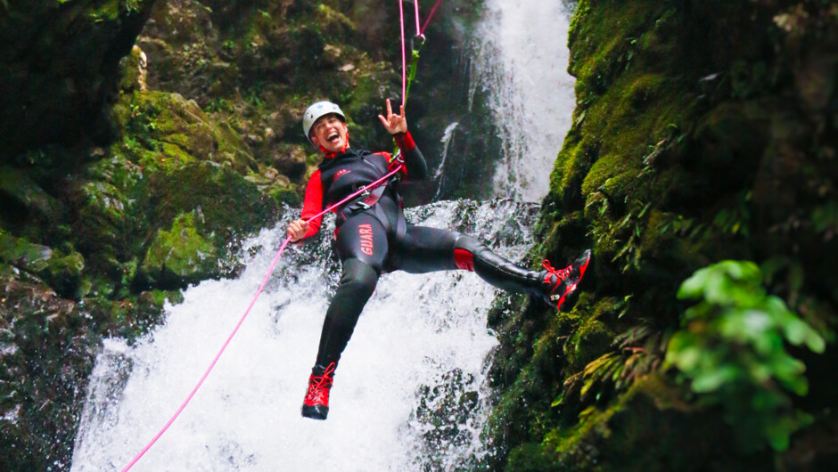 Having fun while abseiling down the big waterfall