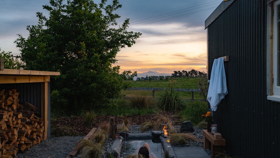 It’s a huge bath for one, or a snuggly top & tail fit for two. Privately located to the east of the Hut, and screened by the woodshed and vegetation. Only the cows and sheep can see you.