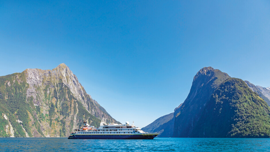 The ship National Geographic Orion in Milford Sound, Fiordlands National Park, Milford Sound, South Island, New Zealand.