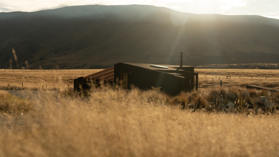 Skylark Cabin features stunning views of golden grasslands and the rugged Ben Ohau mountain range