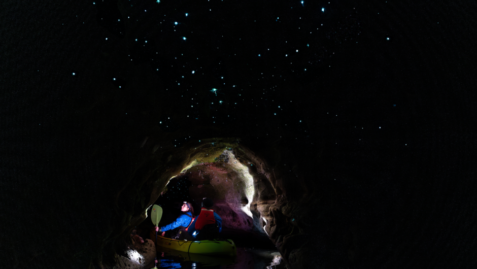 Magical glow worms above kayak