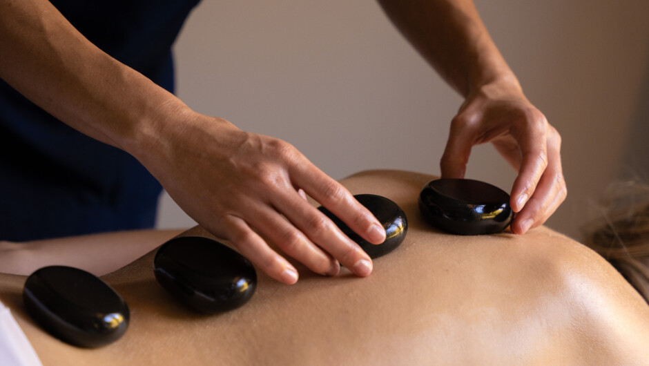 Unwind under the deeply relaxing strokes of a hot stone massage.