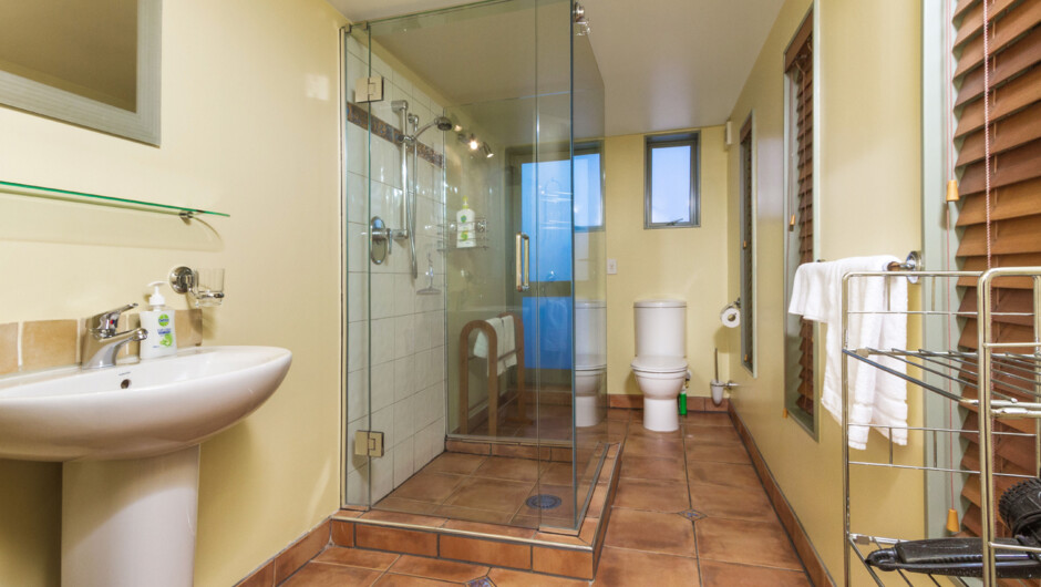 Well appointed tiled bathroom with shower, vanity & toilet