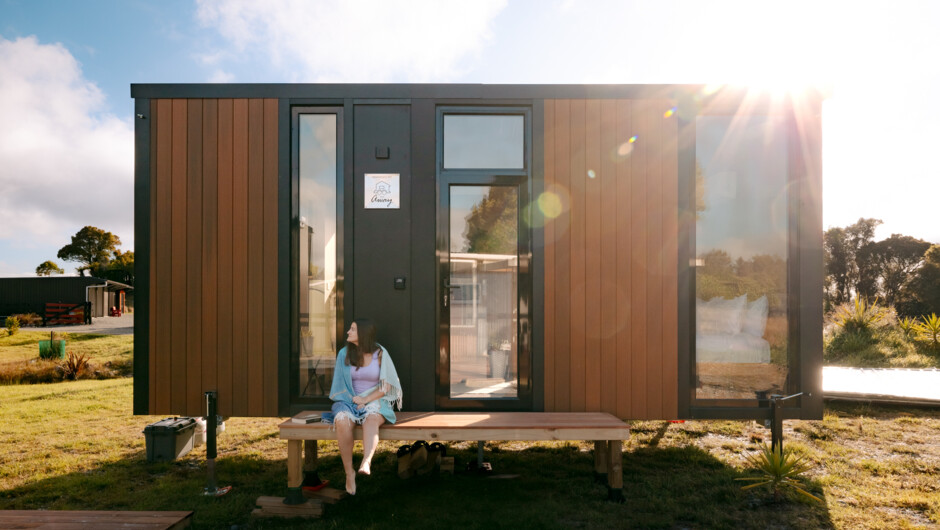 Our tiny house nestled in serene surroundings for a peaceful retreat.