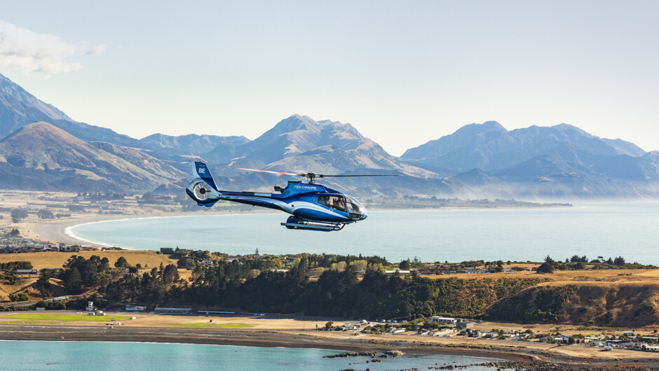 South Pacific Helicopters EC130 flying over the Kaikoura Peninsula
with Kaikoura Seaward Ranges in the background.