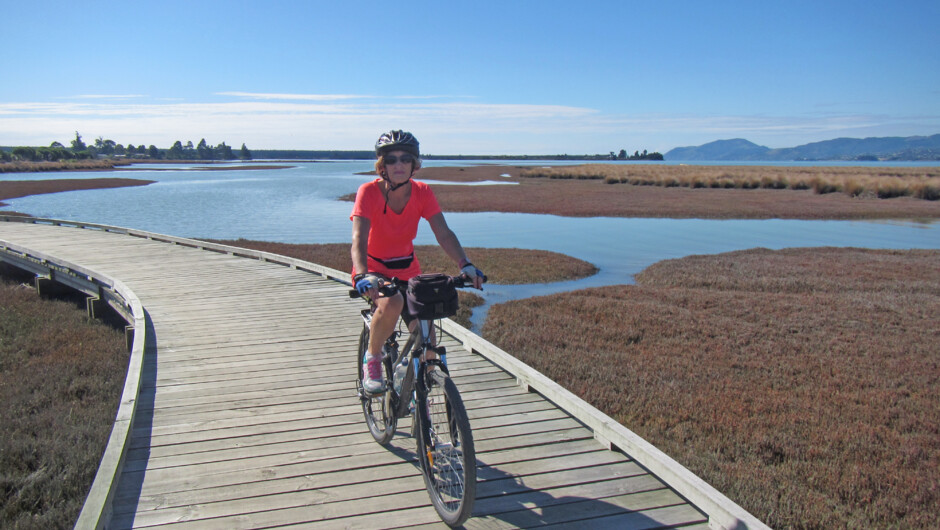 Cycling on the boardwalk in the scenic Waimea Estuary