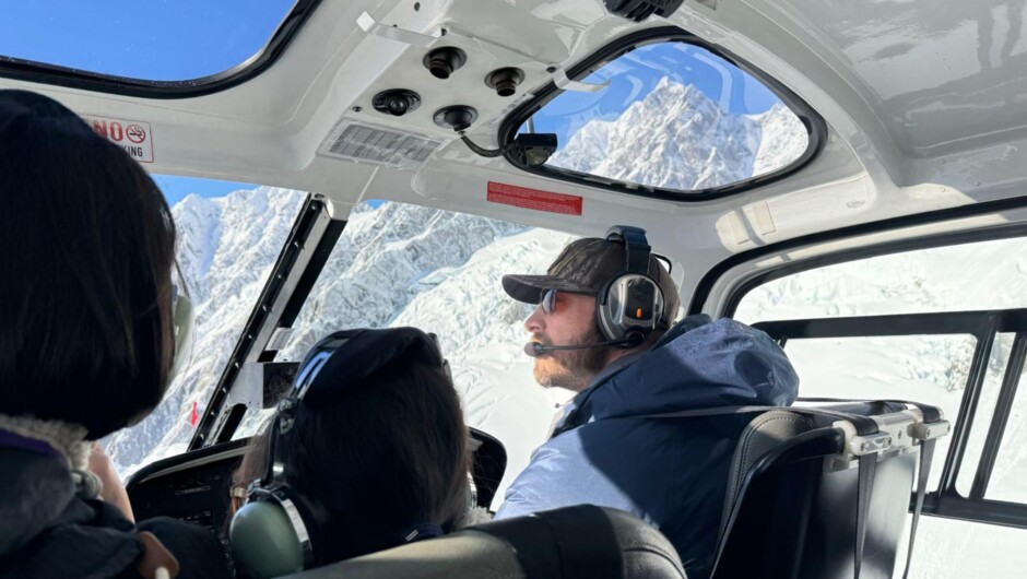 Soaring high above the icy expanse of the Franz Josef Glacier—an adventure of a lifetime with stunning aerial views.