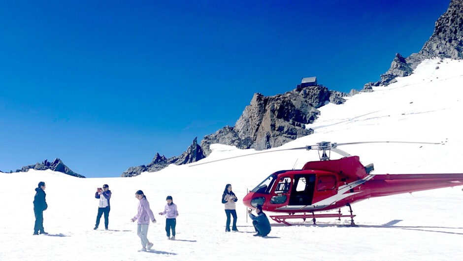 Landing on the snowfield, surrounded by majestic peaks and breathtaking landscapes.