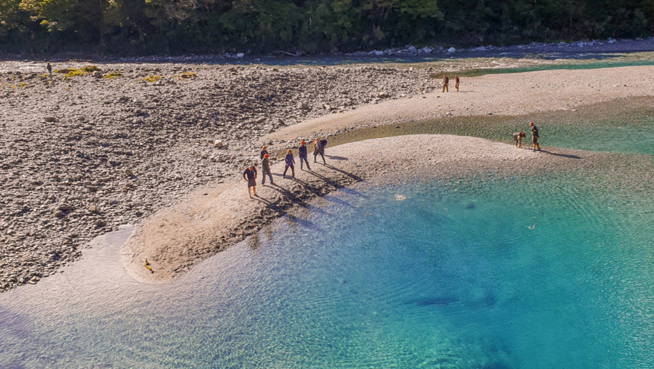 Guests skipping stones at the Blue Pools, Haast Pass