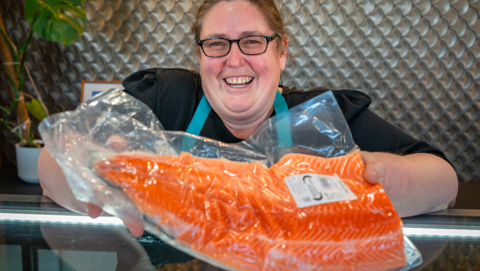 Salmon fillet proudly displayed by Fish Shop staff