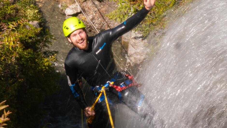 Rappelling down the waterfall after climbing